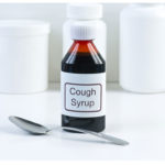 Cough syrup bottle and spoon