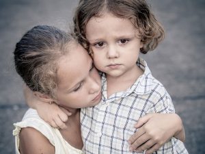 Big sister protecting little brother