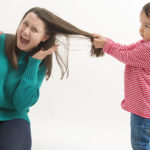 Boy pulling mom s hair