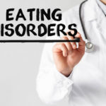 doctor writing Food Disorders on the board