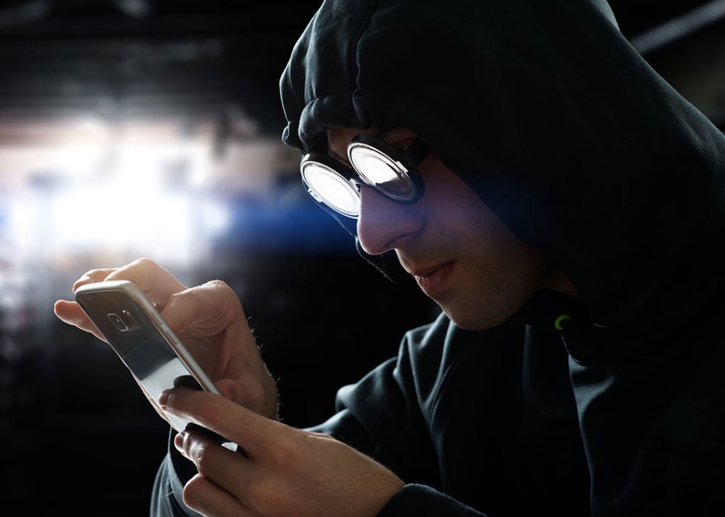 hooded person texting