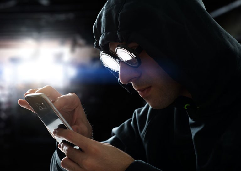 hooded person texting