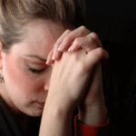 woman praying about addict son