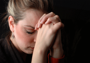 woman praying about addict son