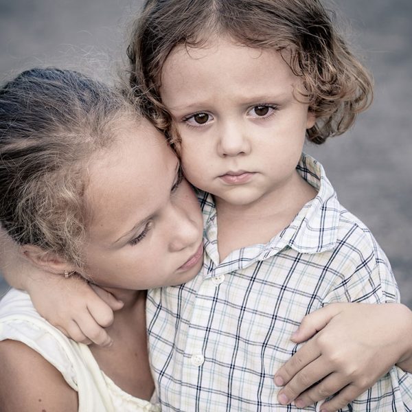 Big sister protecting little brother