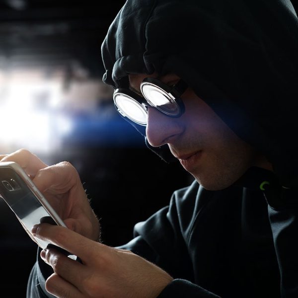 hooded person texting